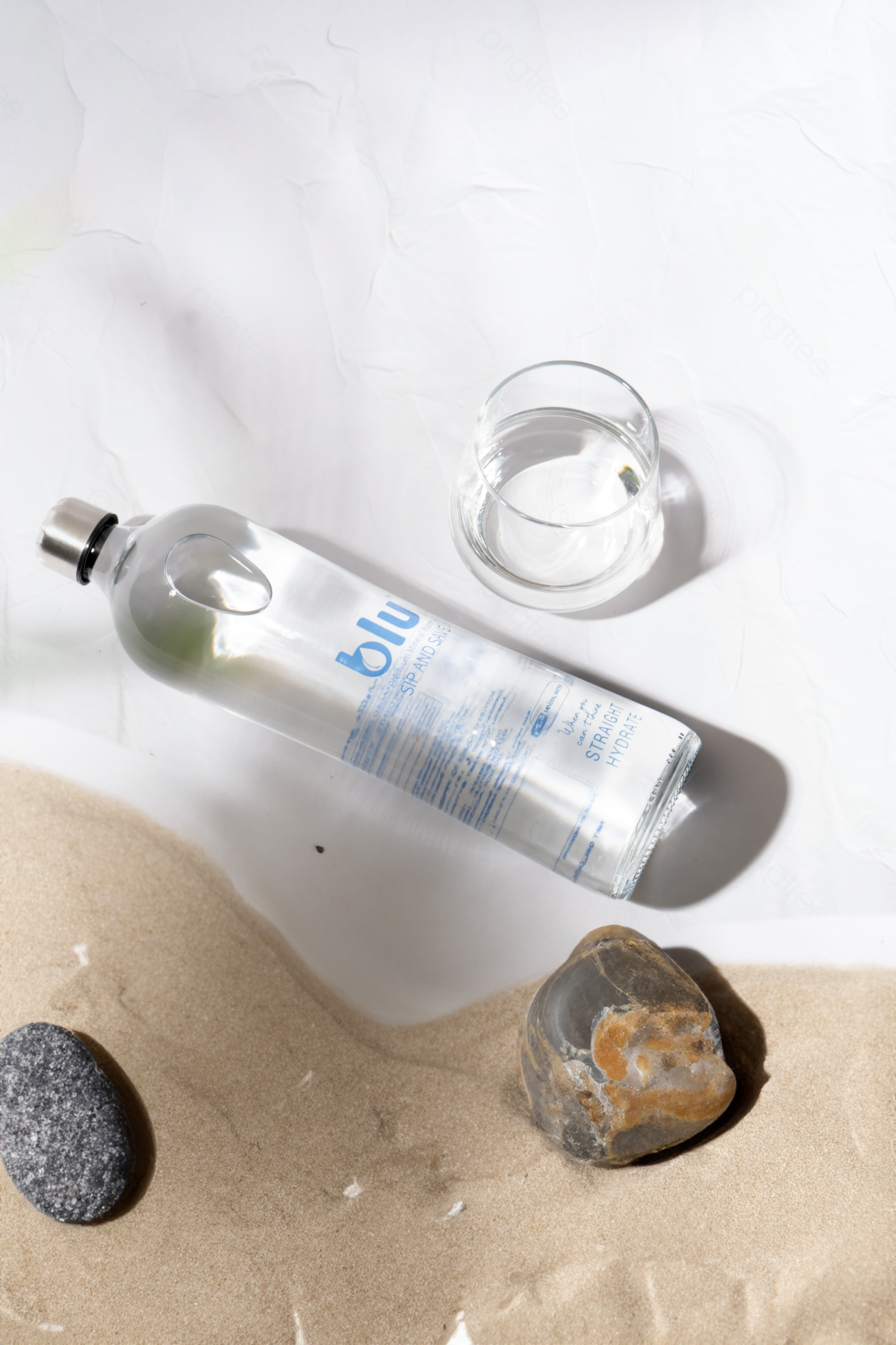 Blu Premium 750ml glass bottle flat lay with natural stones