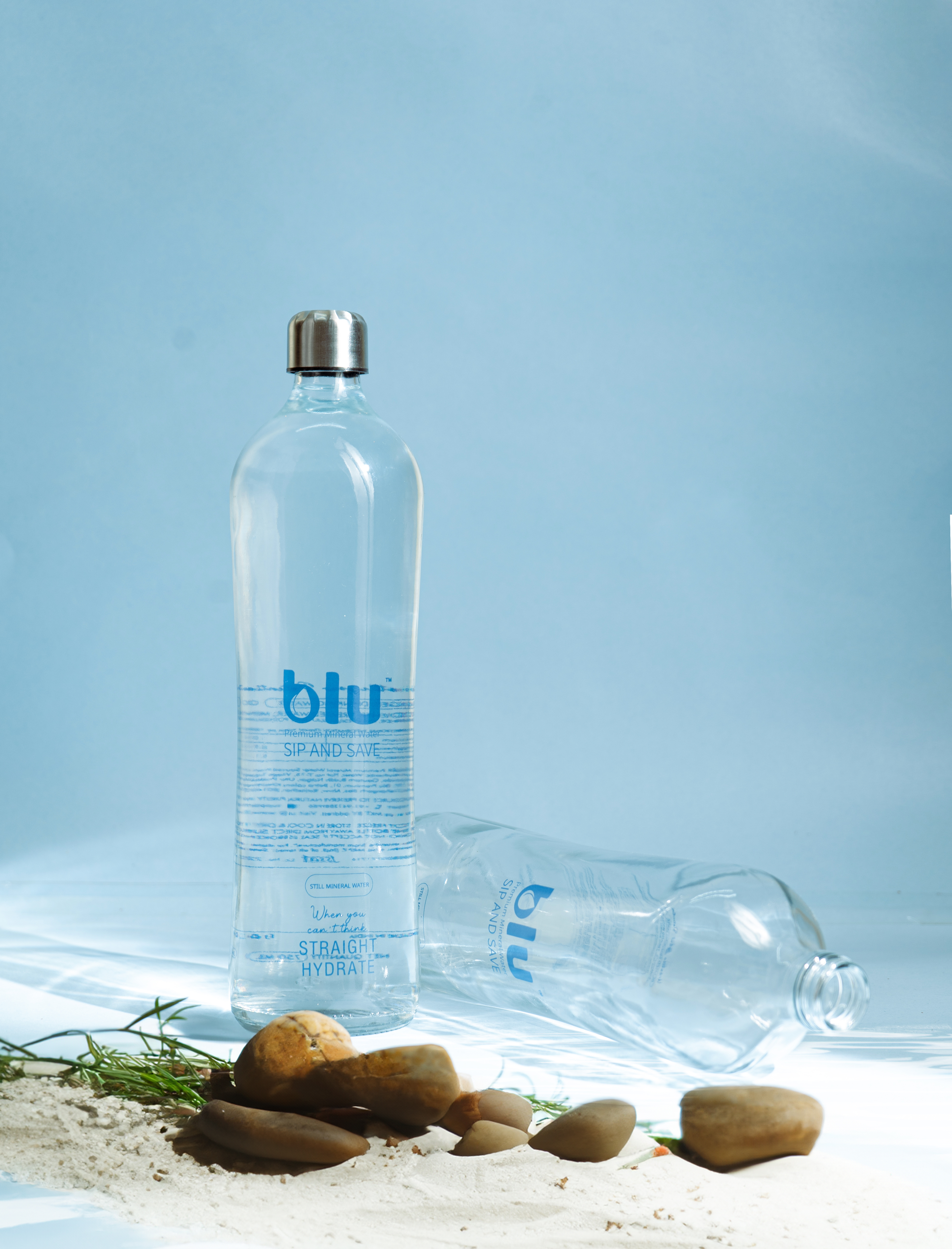 Two Blu Premium bottles with natural elements
